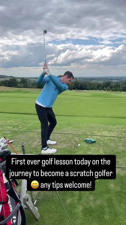 a man is swinging a golf club on a golf course