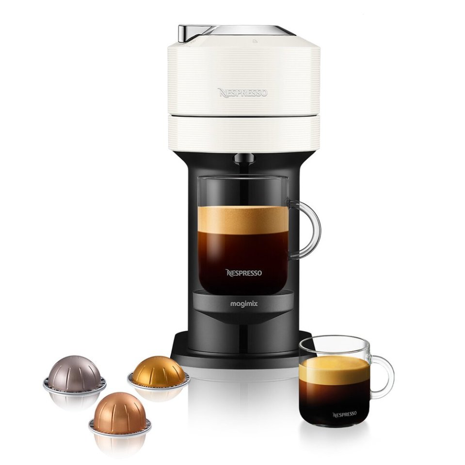 a nespresso machine with a cup of coffee next to it