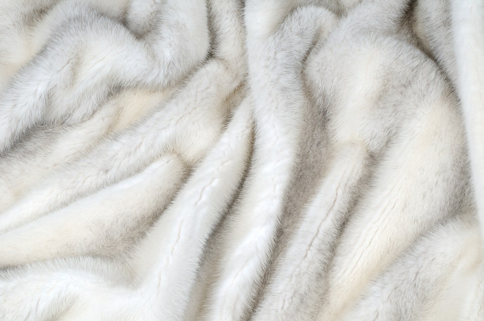 a close up of a white fur blanket