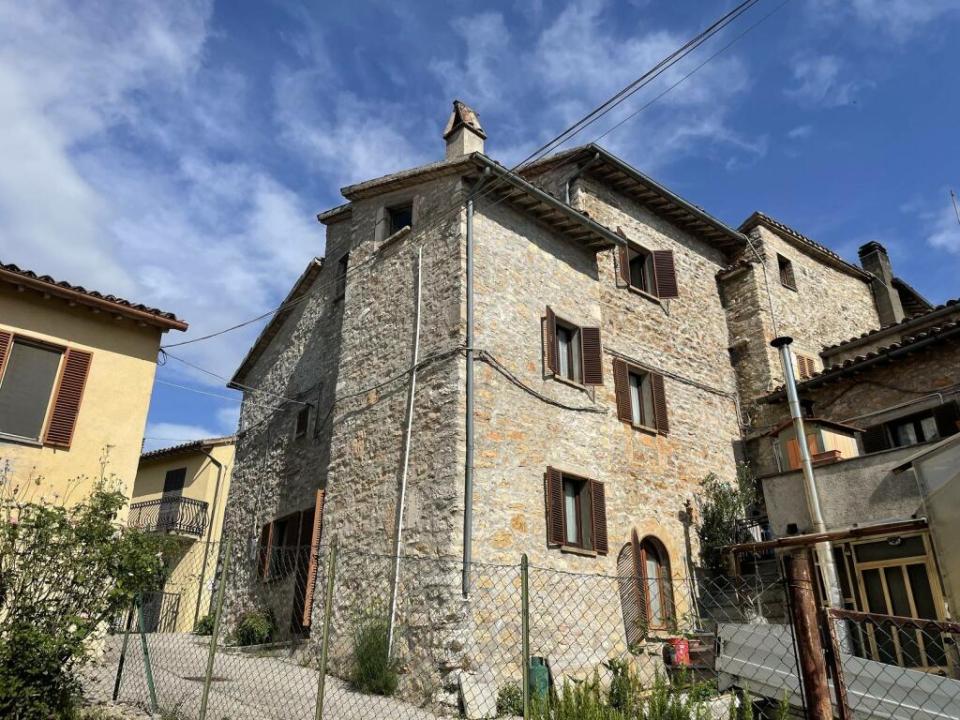 a stone building with a chimney on top of it