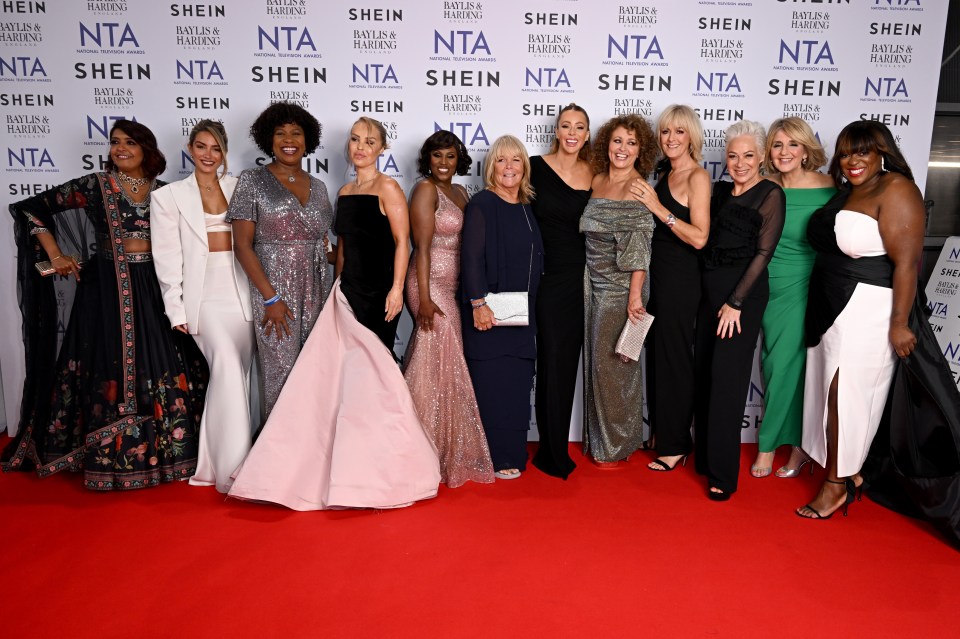 a group of women pose on a red carpet in front of a wall that says shein