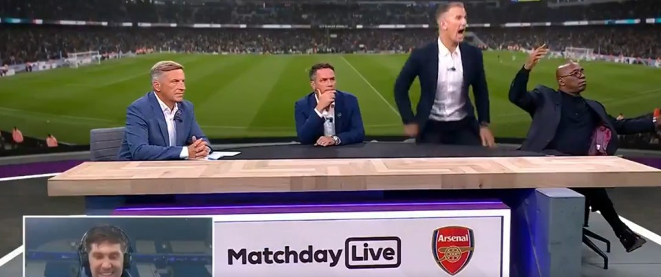 a group of men sit at a table in front of a sign that says matchday live