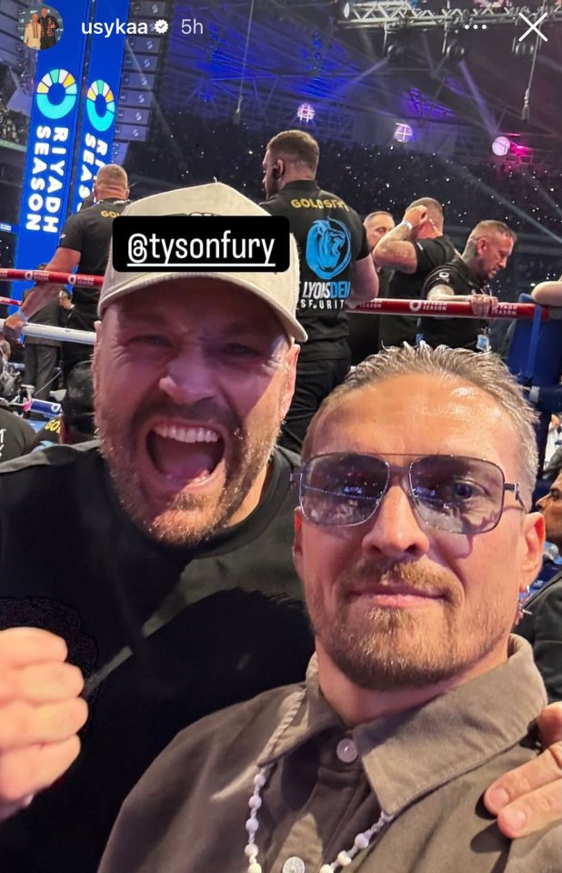 two men are posing for a picture and one has the name tysonfury on his shirt