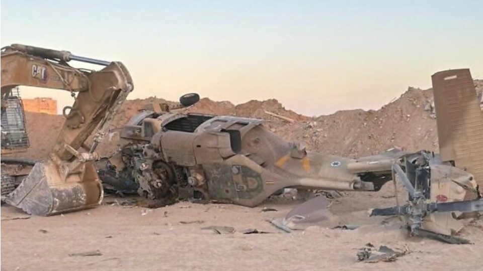 a cat excavator is next to a military vehicle