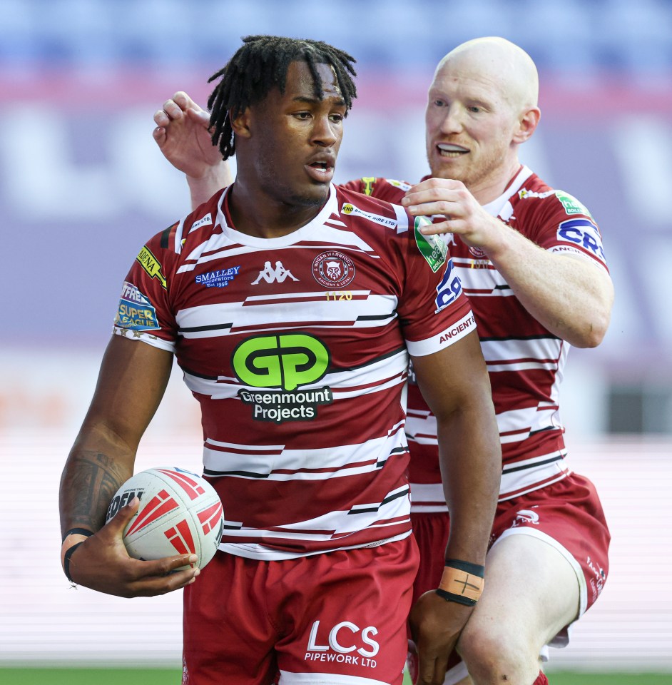 a rugby player wears a jersey that says greenmount projects