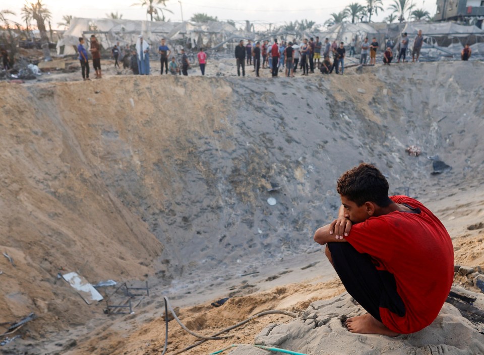 A Palestinian boy looks on at the site following Israeli strikes