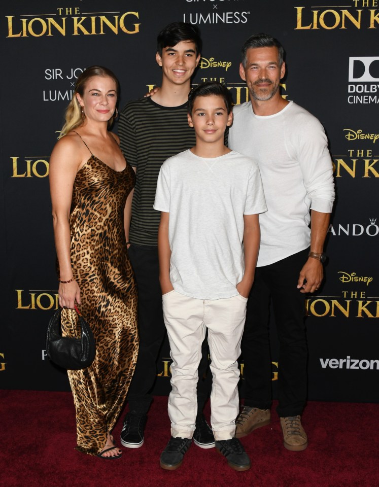 a family poses on the red carpet at the lion king premiere