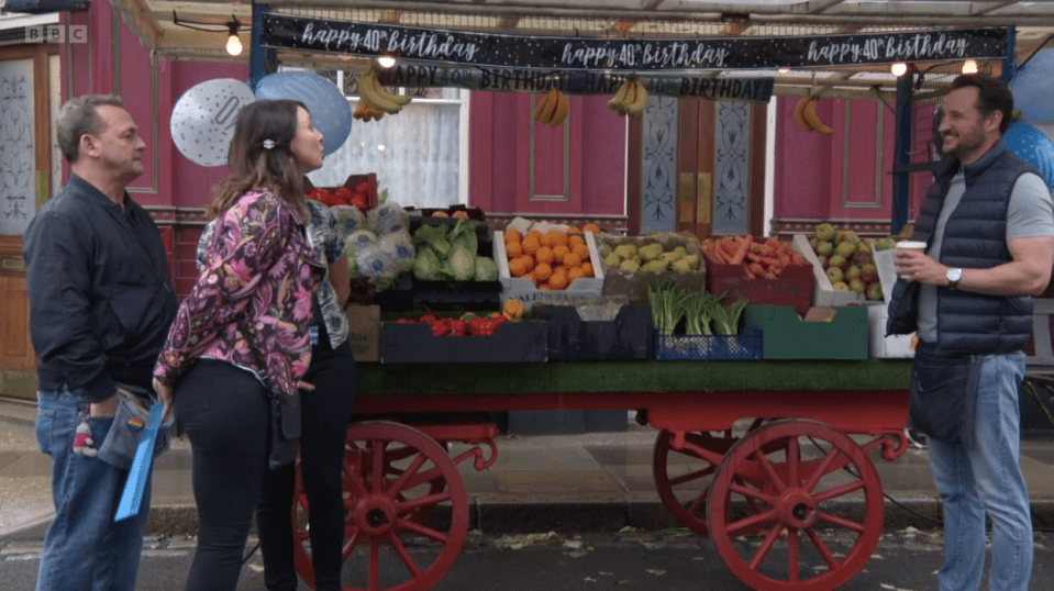 people standing in front of a cart that says happy 40th birthday