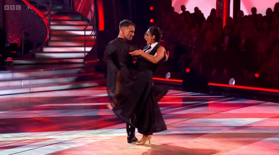 a man and woman are dancing on a stage with bbc written on the bottom