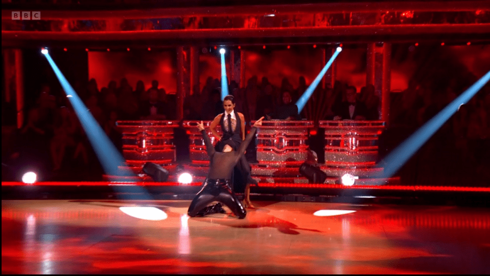 a couple of dancers on a stage with bbc written on the bottom right