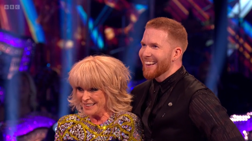 a man and a woman on a stage with bbc written on the bottom