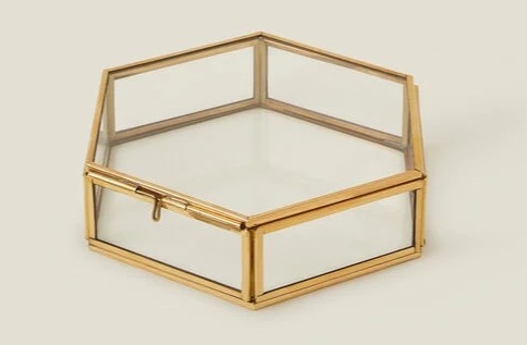 a hexagon shaped glass box with a gold frame