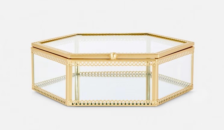 a hexagonal glass box with a gold frame