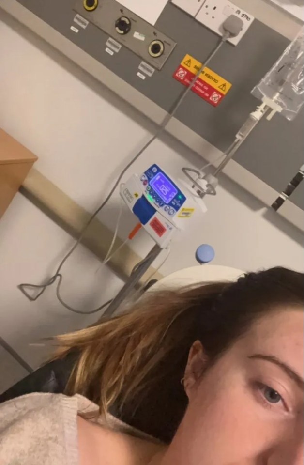 a woman is laying in a hospital bed with a machine that says 5:05 on it