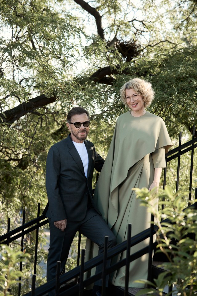 a man and a woman standing next to each other on a set of stairs