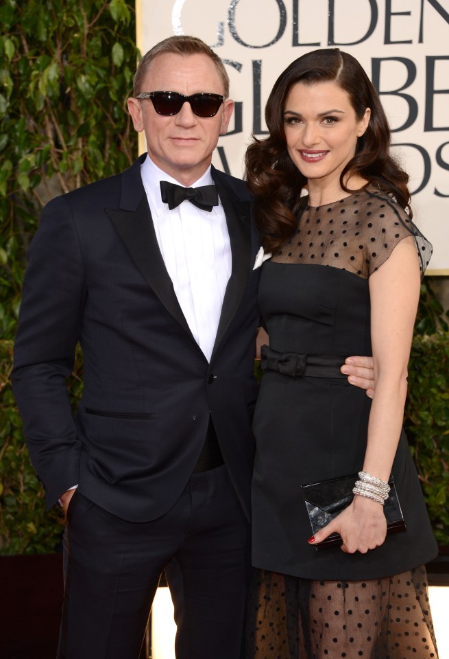 a man and woman are posing for a picture at the golden globe awards