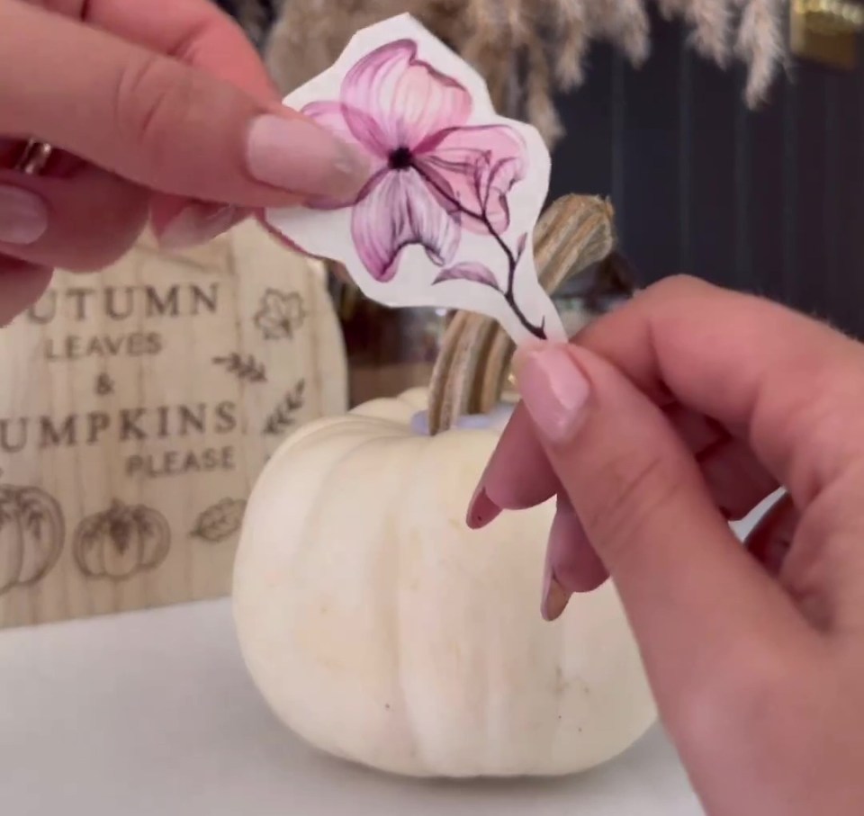 a person is holding a piece of paper that says easy floral pumpkin