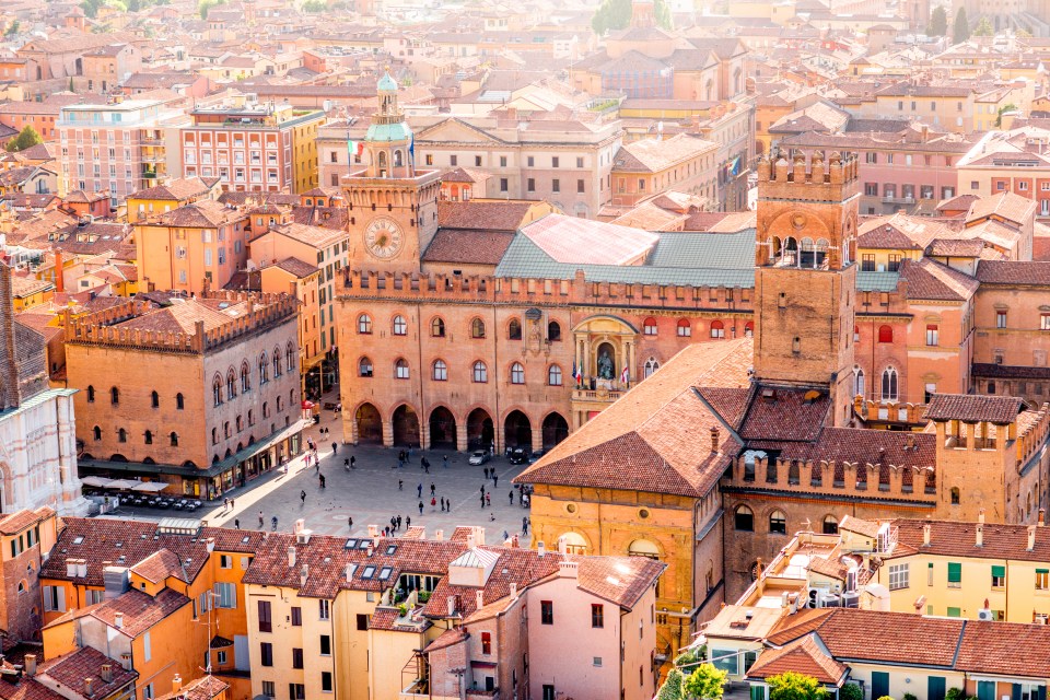 an aerial view of a city with a clock tower in the middle