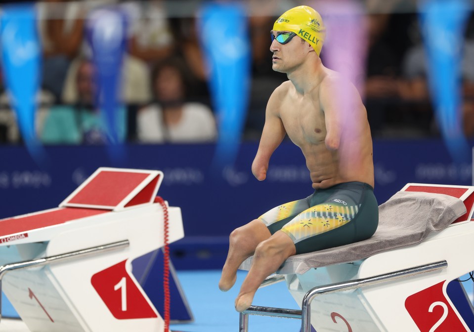 a man with a yellow swim cap that says kelly on it