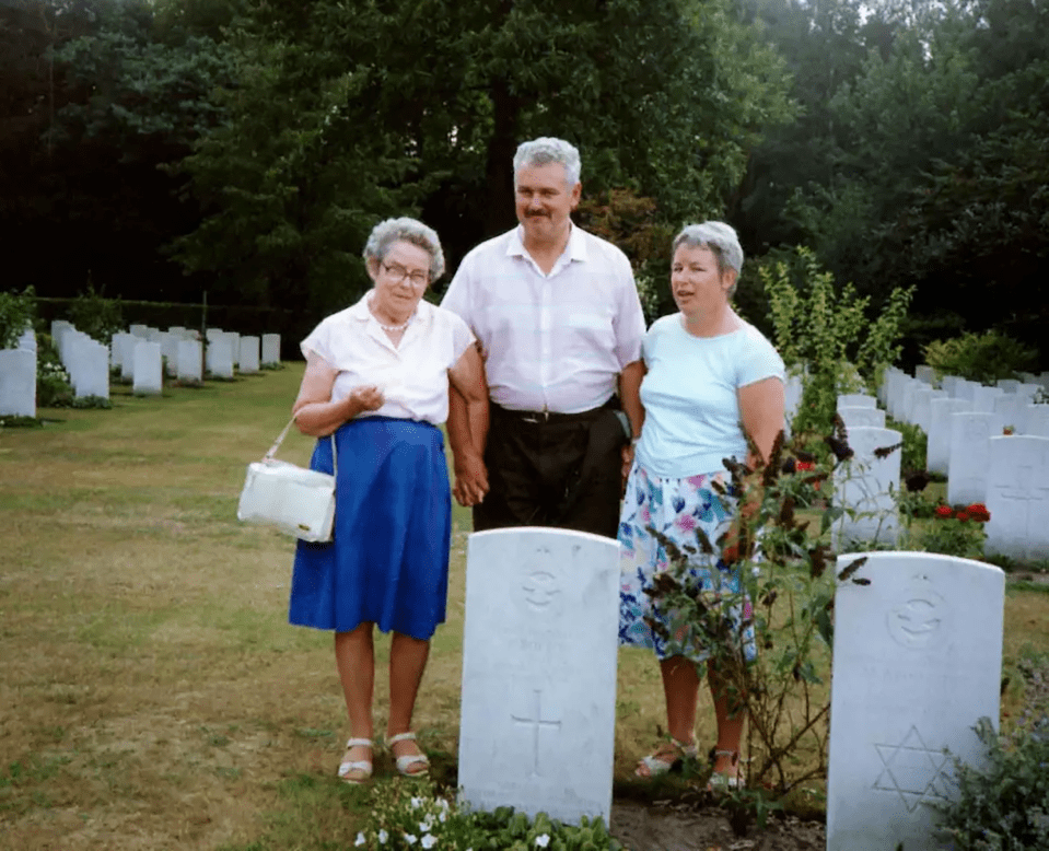 Jean Bolton, Frank's widow, alongside their son Michael and daughter Margaret at Frank's grave