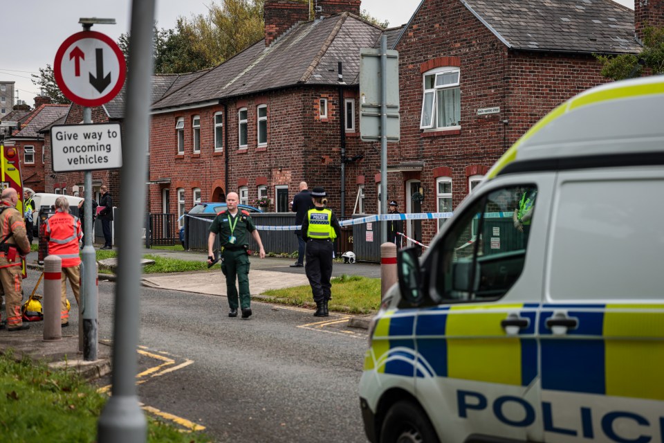 A woman, 40, and a girl, 8, were both found dead inside a house in Salford this morning