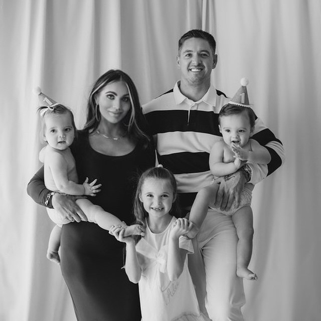 a black and white photo of a family posing for a picture