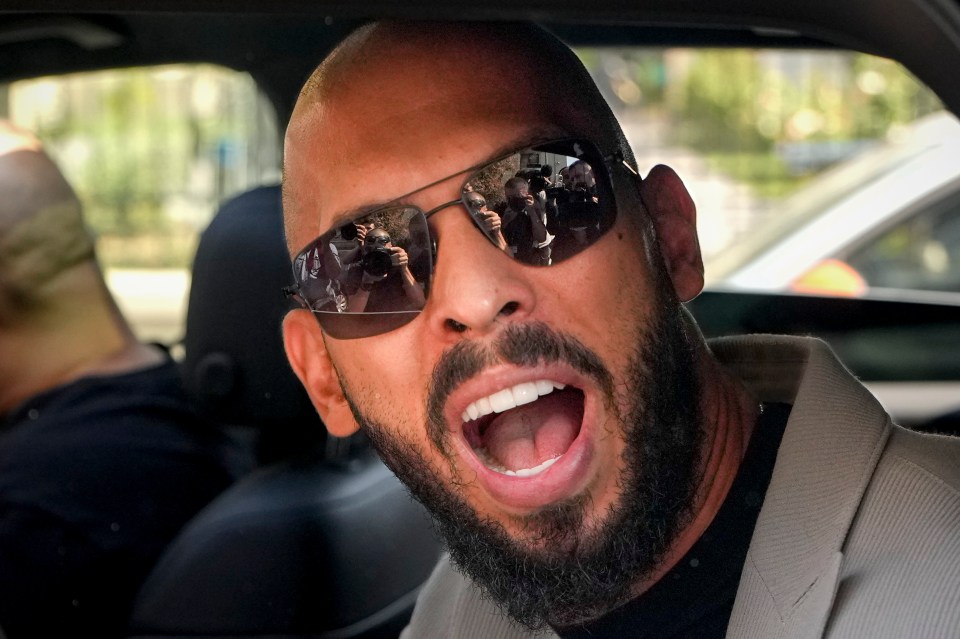 a bald man with a beard wearing sunglasses with his mouth open