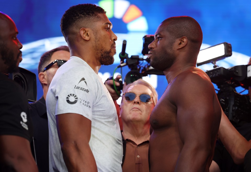 two men are facing each other and one has a shirt that says ' united kingdom ' on it