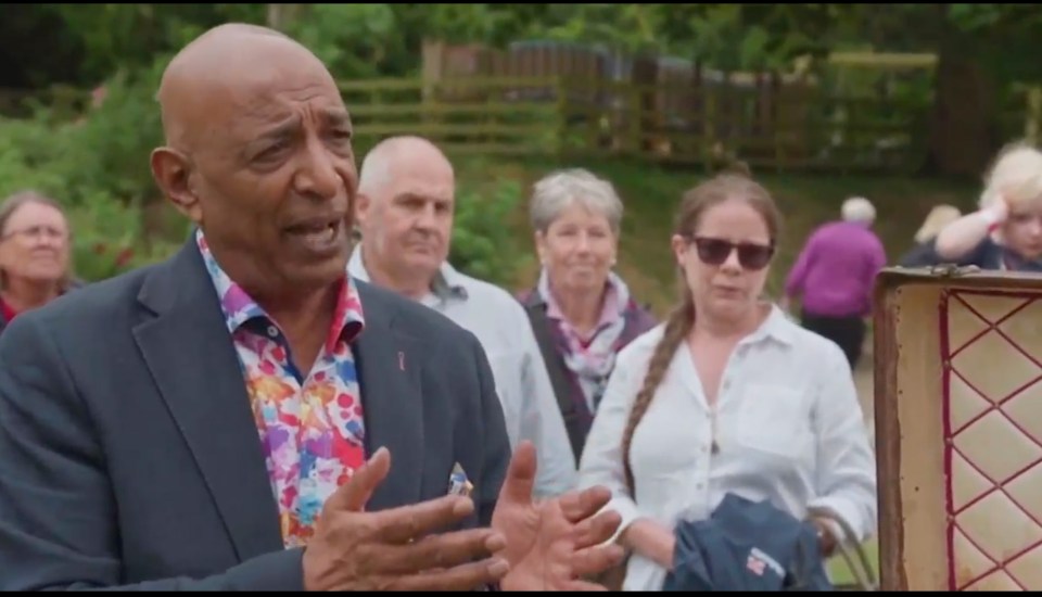 a man in a suit is talking to a group of people