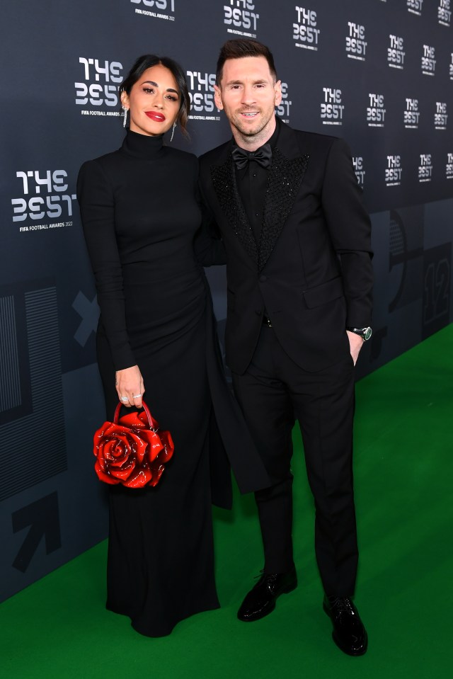 a man and woman are posing for a picture on a green carpet that says the best