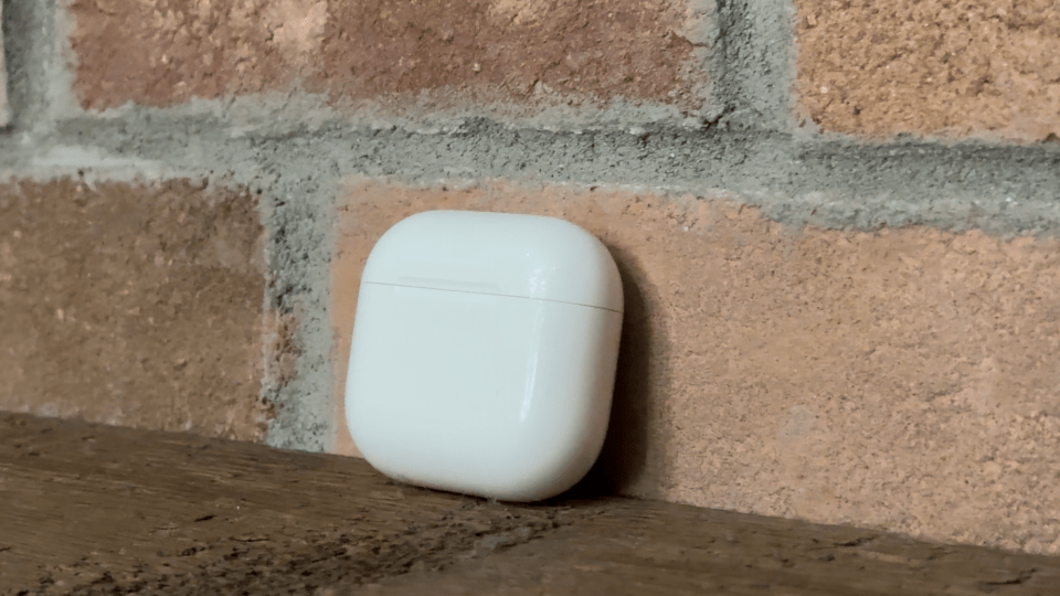 a white object is leaning against a brick wall