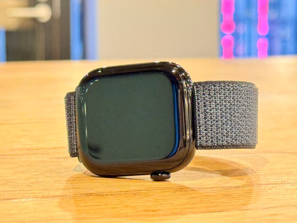 a smart watch is sitting on a wooden table