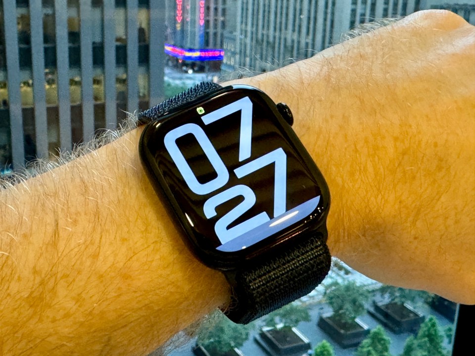 a man wearing an apple watch shows the time as 6:27