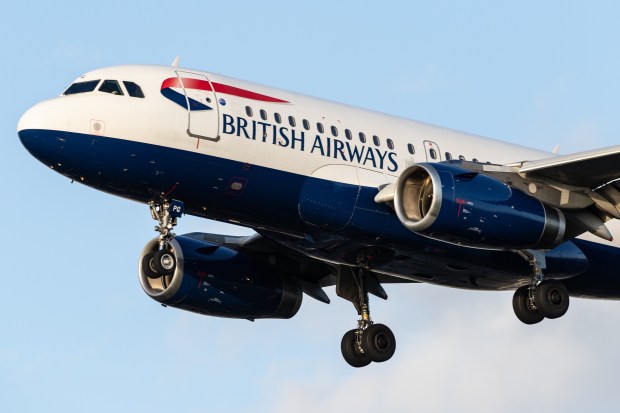 a british airways plane is flying through the air