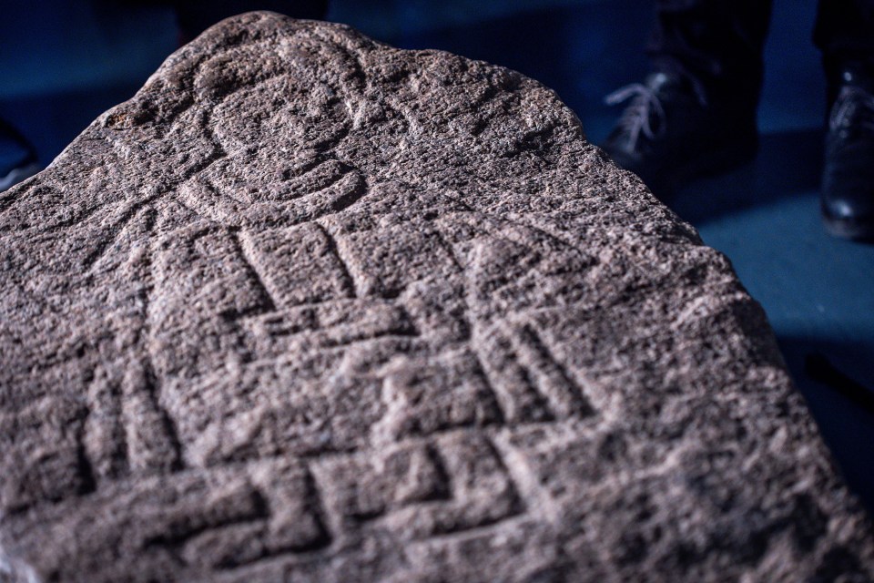 a stone with a drawing of a man on it