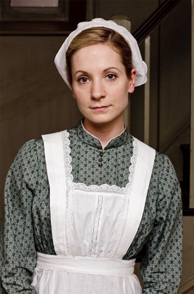 a woman wearing a white apron and a white hat