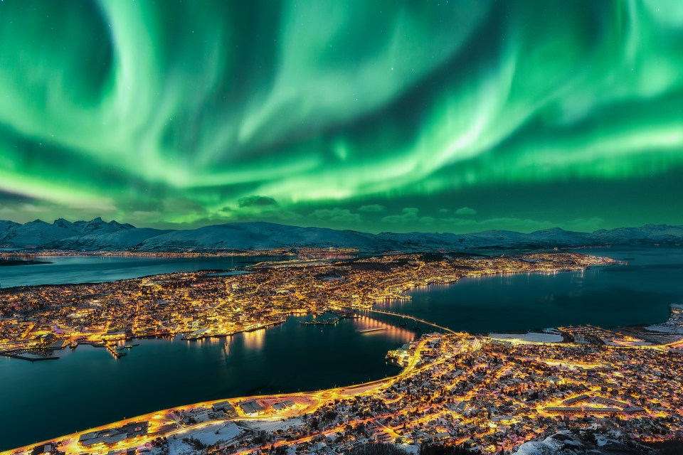 an aerial view of the aurora borealis over a city