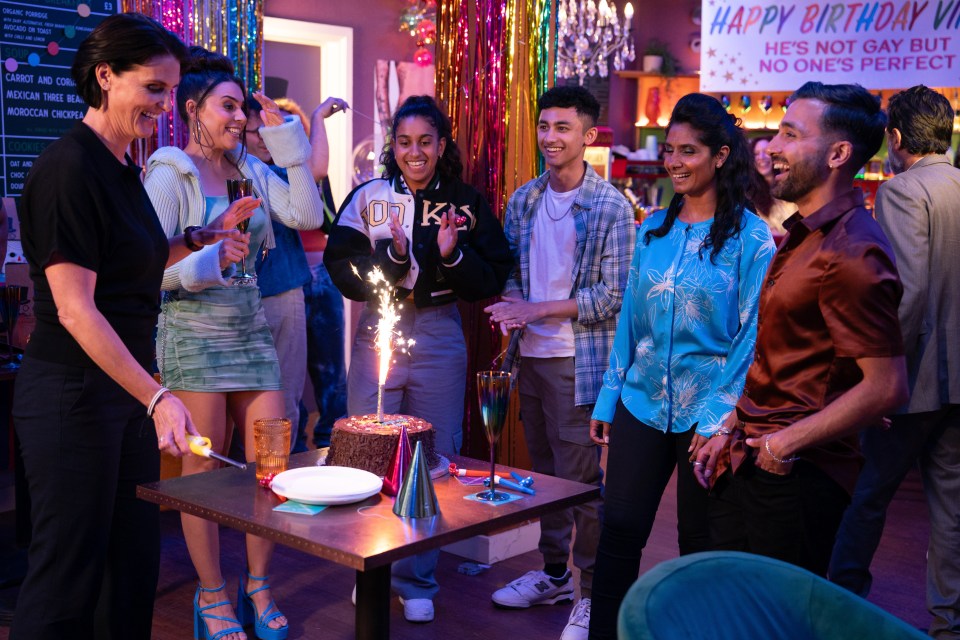 a group of people are celebrating a birthday with a sign that says happy birthday vi