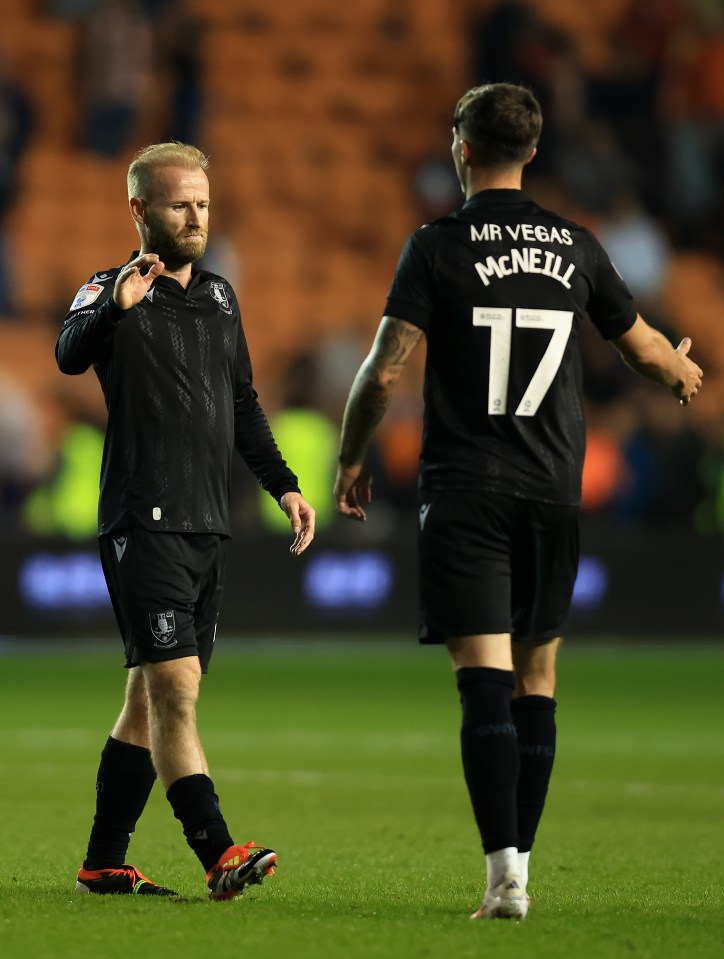 McNeill is congratulated by Owls team-mate Barry Bannan