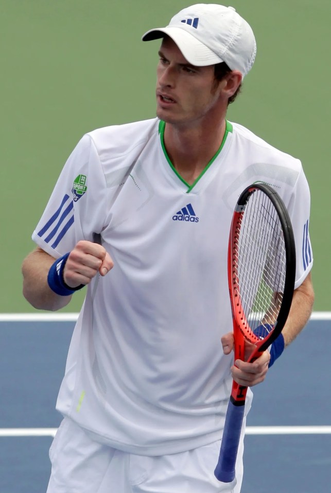 a man wearing a white adidas shirt is holding a tennis racquet