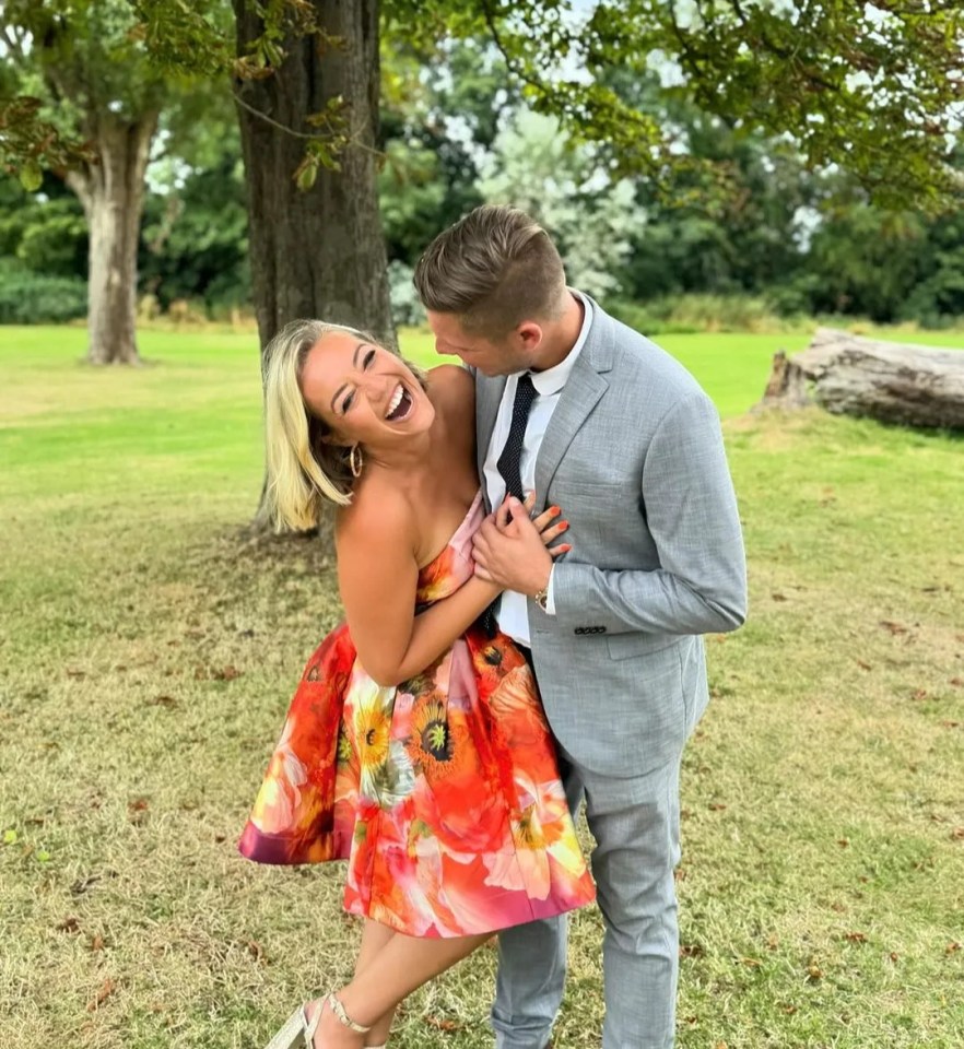 a man in a suit kisses a woman in a floral dress