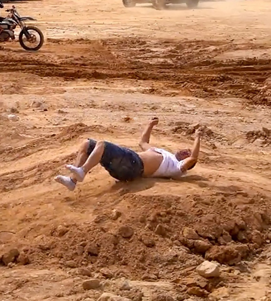 a man is laying on his back in the dirt