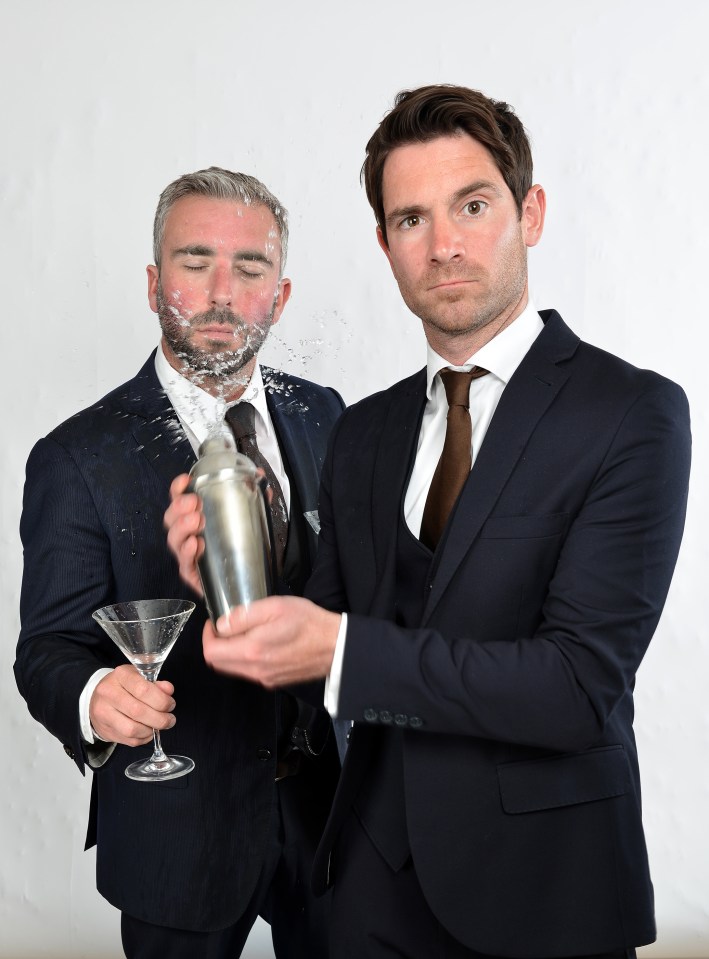 a man in a suit holds a shaker and a martini glass