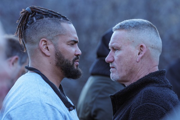 two men are looking at each other and one has dreadlocks