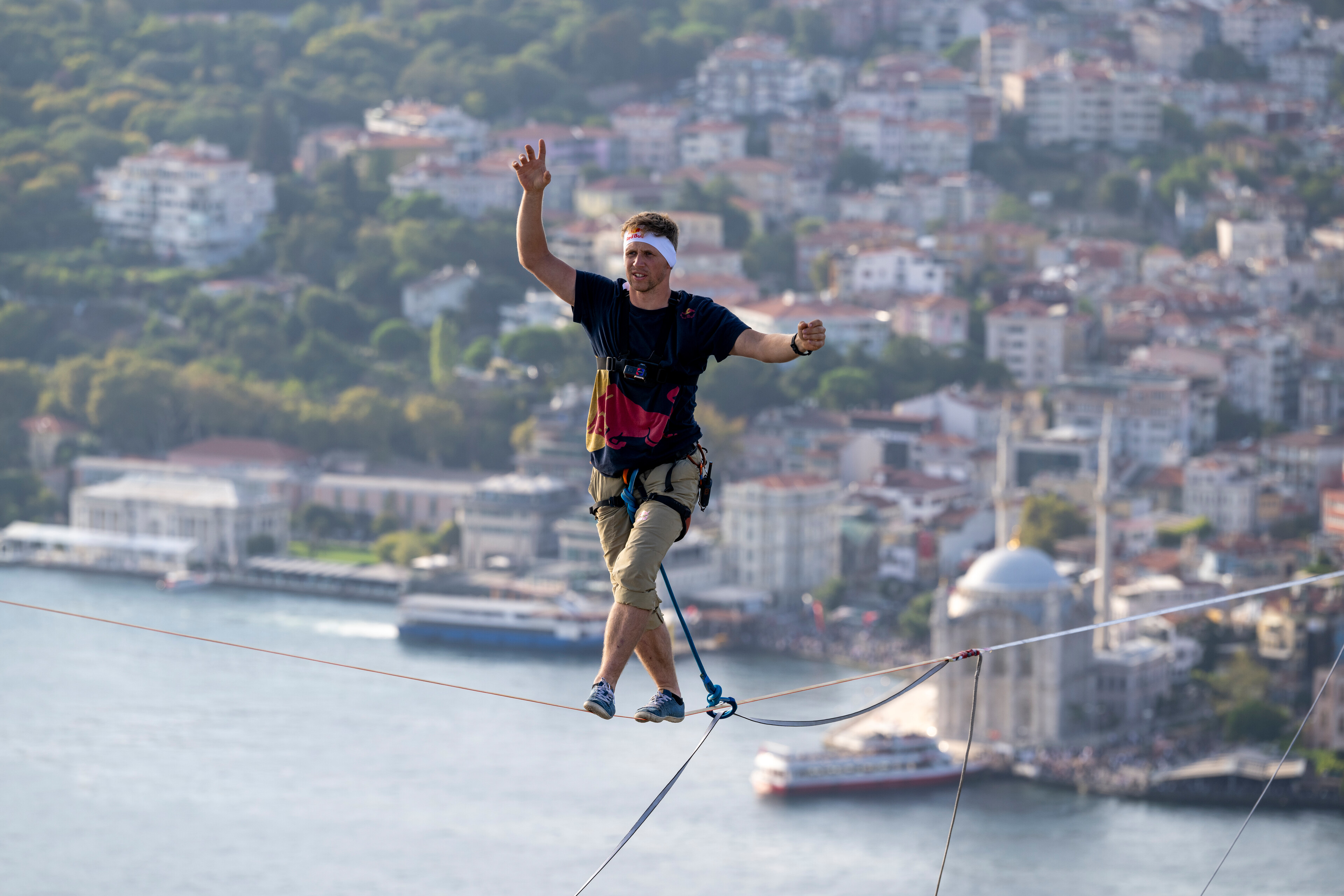 a man is walking on a tightrope over a body of water