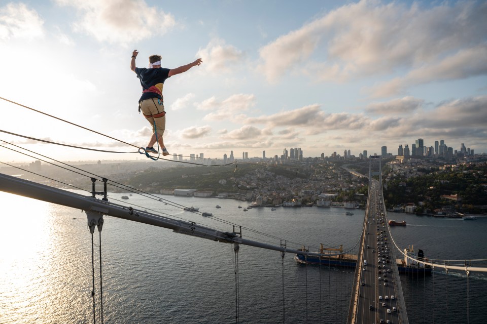 a man walking on a tightrope over a body of water