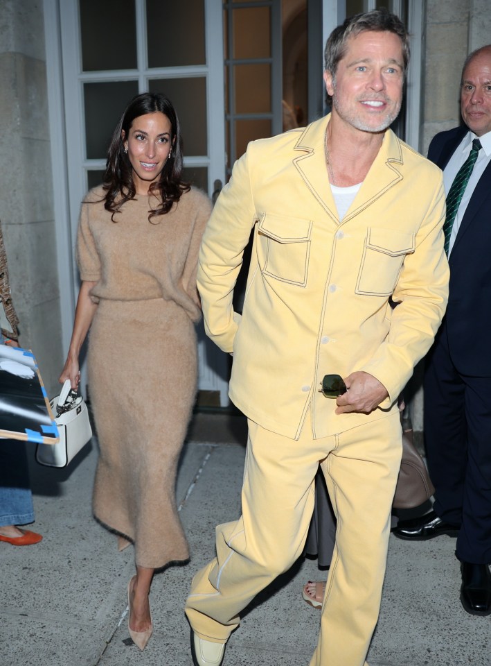 Brad Pitt sporting a lemon yellow jacket and matching flared trousers for a night out with Ines