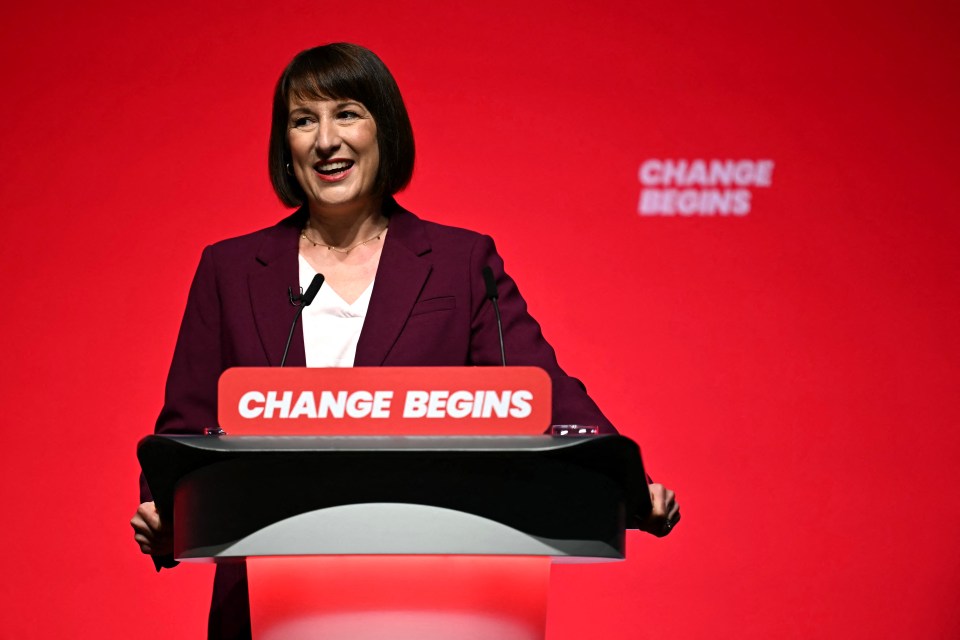 a woman stands behind a podium that says change begins