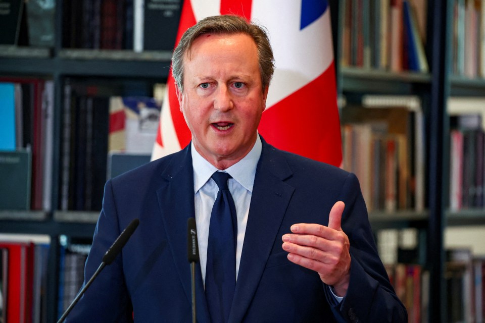 a man in a suit and tie is speaking into a sennheiser microphone