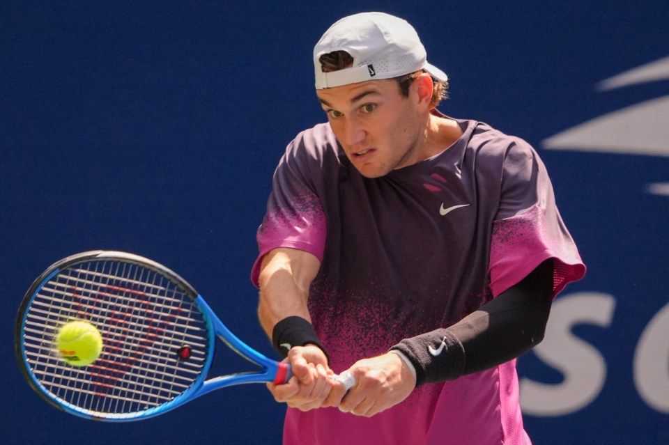 a man in a nike shirt is playing tennis